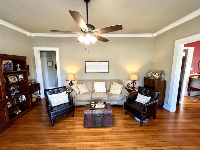 living room with hardwood / wood-style floors, ceiling fan, and crown molding