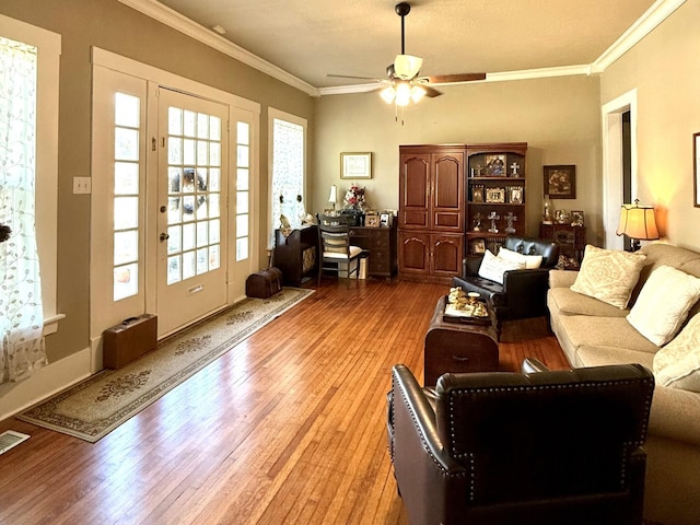 living room with ceiling fan, light hardwood / wood-style floors, and ornamental molding