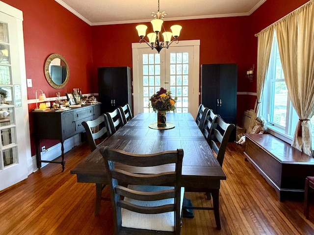 dining room with a chandelier, dark hardwood / wood-style flooring, plenty of natural light, and crown molding