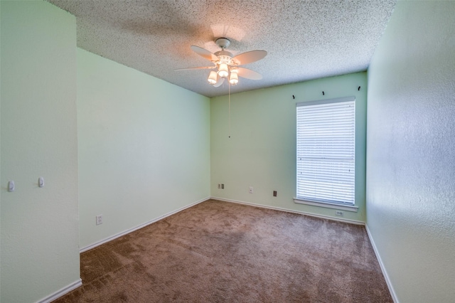 carpeted spare room with ceiling fan and a textured ceiling