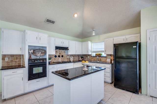 kitchen featuring sink, white cabinetry, a kitchen island, and black appliances