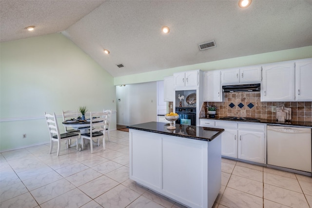 kitchen with white cabinets, decorative backsplash, white dishwasher, and oven