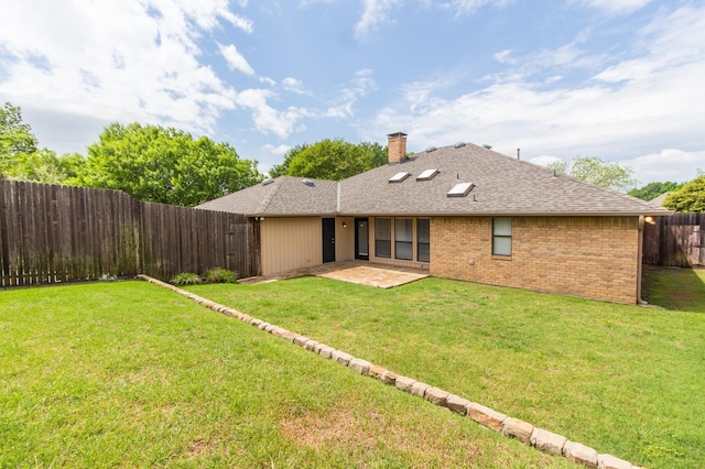 back of property with a patio area and a yard