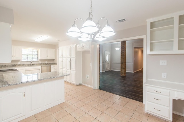 kitchen featuring decorative light fixtures, dishwasher, white cabinetry, and light hardwood / wood-style flooring