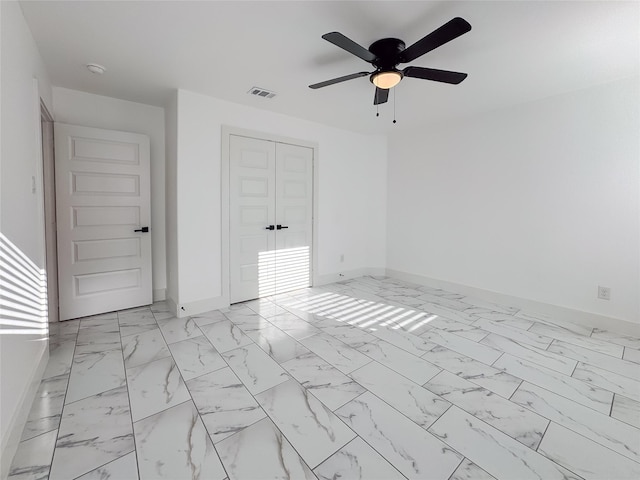 609 E 14th Ave, Corsicana, TX 75110 - empty room with baseboards, a ceiling fan, and light marble finish floors