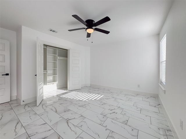 609 E 14th Ave, Corsicana, TX 75110 - unfurnished bedroom featuring baseboards, light marble finish floors, a closet, and ceiling fan
