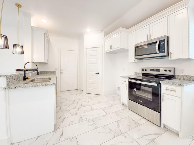 kitchen featuring white cabinets, decorative light fixtures, stainless steel appliances, and sink