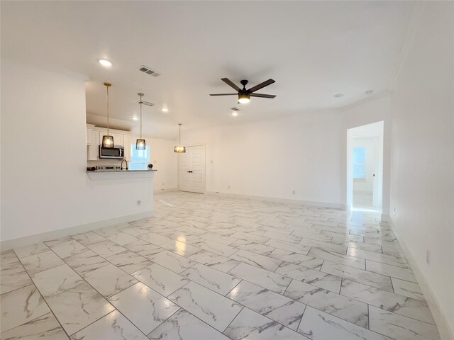 609 E 14th Ave, Corsicana, TX 75110 - unfurnished living room featuring baseboards, recessed lighting, ceiling fan, a sink, and light marble finish flooring