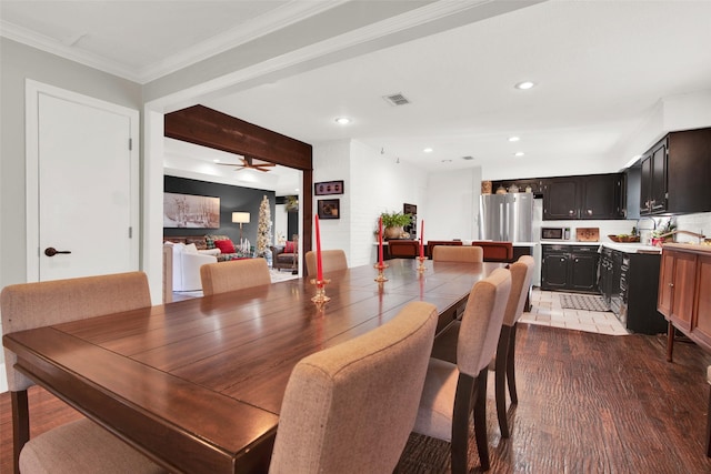 dining area featuring beam ceiling, light hardwood / wood-style flooring, ceiling fan, and ornamental molding