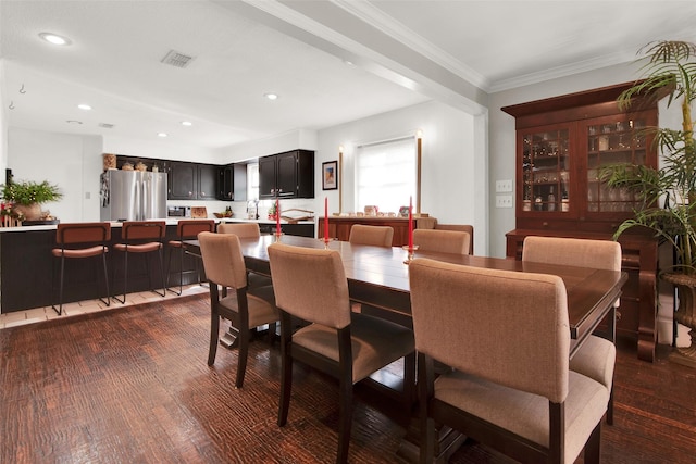 dining area featuring dark hardwood / wood-style flooring and ornamental molding