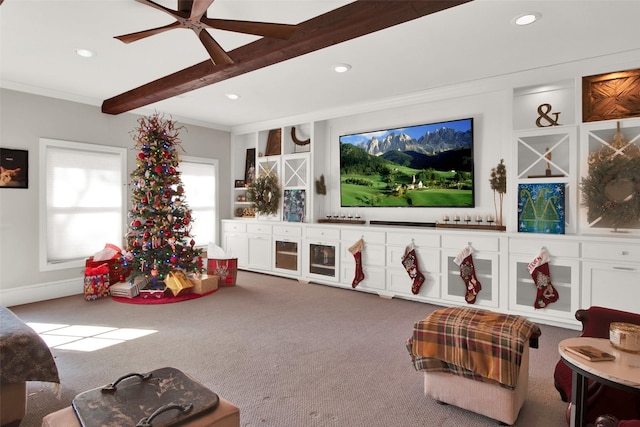 living room featuring beamed ceiling, carpet, ceiling fan, and crown molding