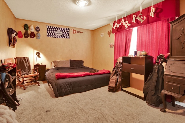 bedroom with a textured ceiling and carpet floors