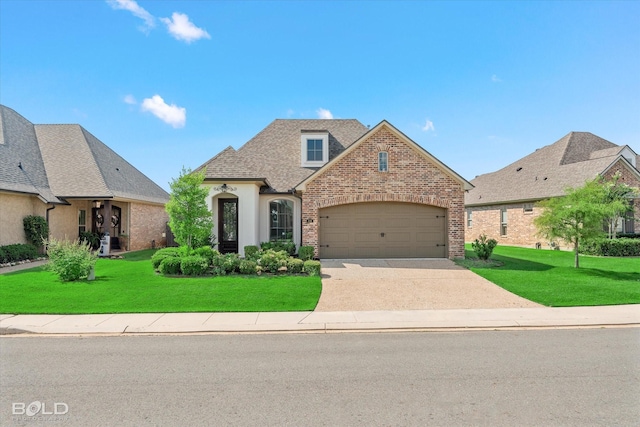 view of front of house featuring a garage and a front yard