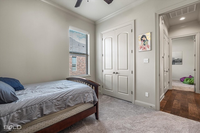 carpeted bedroom featuring ornamental molding and ceiling fan