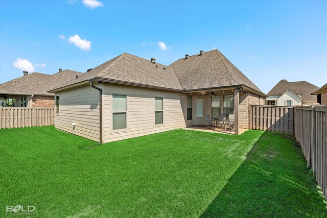 rear view of house featuring a patio, a yard, and ceiling fan