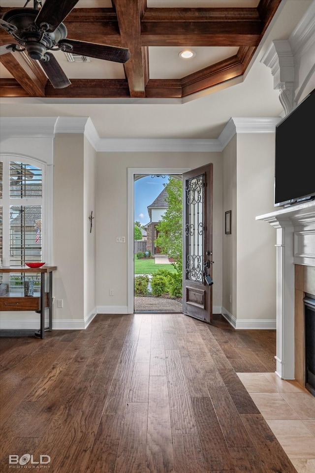 foyer featuring coffered ceiling, hardwood / wood-style floors, crown molding, and a healthy amount of sunlight