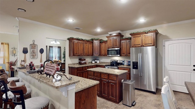 kitchen featuring appliances with stainless steel finishes, a kitchen breakfast bar, light stone counters, crown molding, and an island with sink