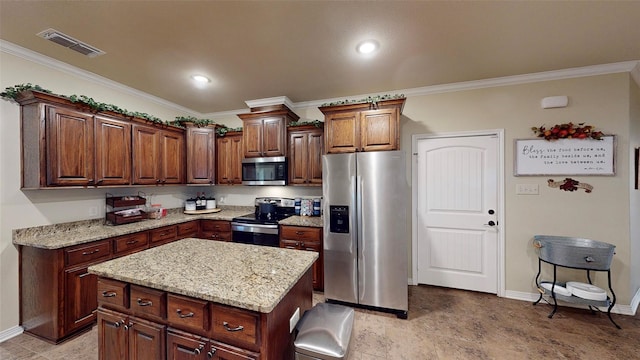 kitchen featuring a kitchen island, ornamental molding, and appliances with stainless steel finishes