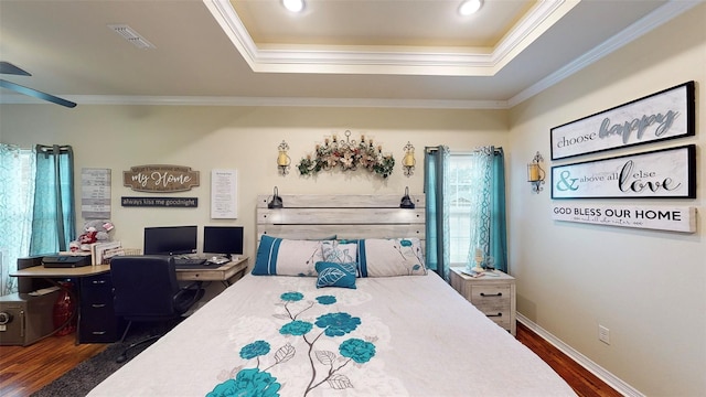 bedroom featuring a raised ceiling, crown molding, ceiling fan, and dark wood-type flooring