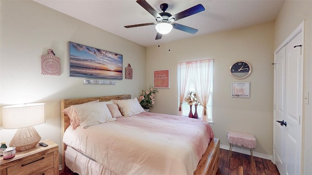 bedroom featuring a closet, dark hardwood / wood-style floors, and ceiling fan