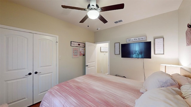 bedroom with hardwood / wood-style floors, a closet, and ceiling fan