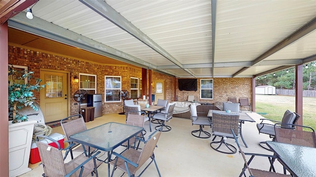 view of patio / terrace with an outdoor hangout area and a shed