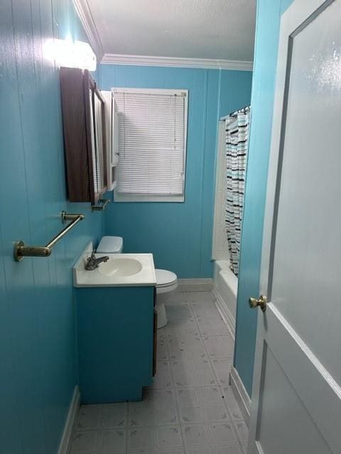 full bathroom with crown molding, vanity, shower / bath combination with curtain, and toilet