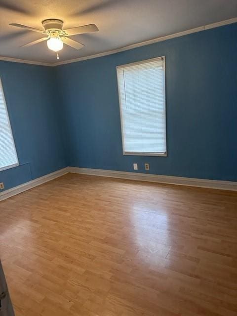 empty room featuring ceiling fan, ornamental molding, and light hardwood / wood-style flooring