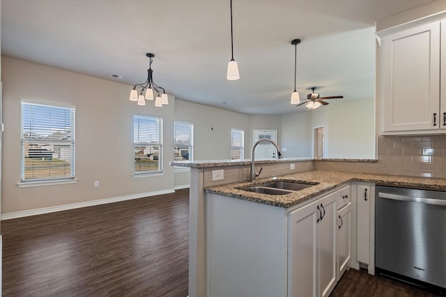 kitchen with kitchen peninsula, stainless steel dishwasher, dark wood-type flooring, sink, and white cabinetry