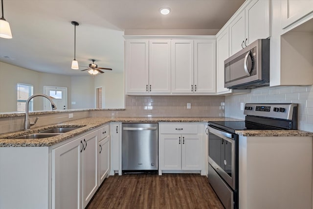 kitchen with white cabinets, pendant lighting, sink, and stainless steel appliances