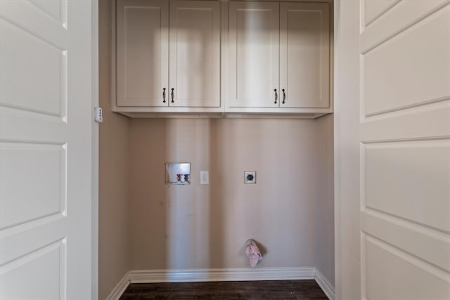 clothes washing area featuring cabinets, hookup for a washing machine, dark hardwood / wood-style floors, and hookup for an electric dryer