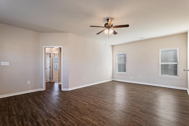 empty room featuring ceiling fan and dark wood-type flooring