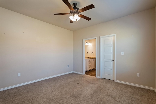 unfurnished bedroom with carpet floors, ensuite bath, and ceiling fan