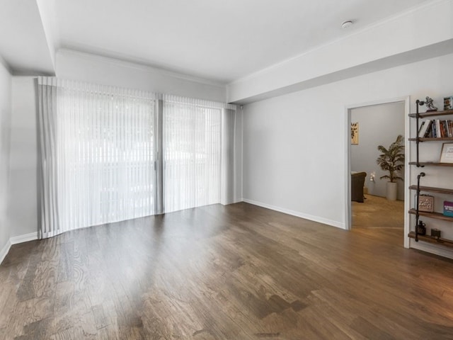 unfurnished room featuring dark hardwood / wood-style flooring and ornamental molding