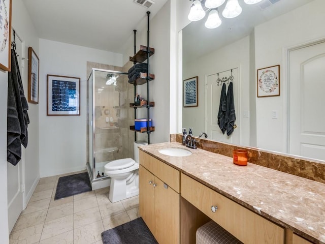 bathroom with vanity, toilet, and a shower with shower door