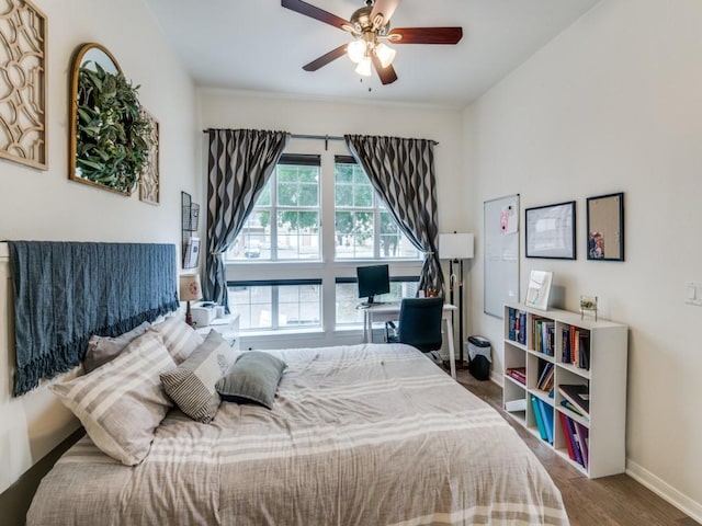 bedroom with hardwood / wood-style flooring and ceiling fan