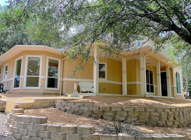 back of house with stucco siding