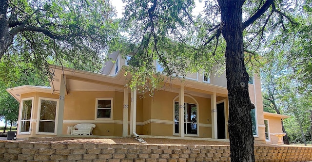 back of house with stucco siding