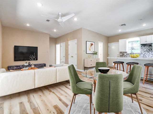 dining room featuring light wood finished floors, visible vents, and recessed lighting