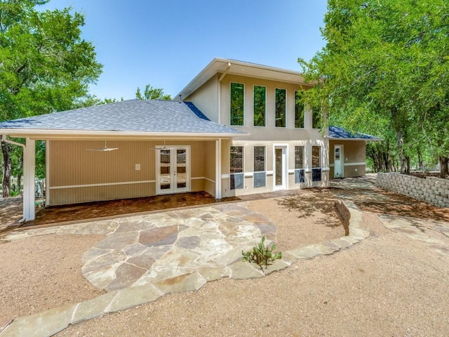 back of house with french doors and a shingled roof