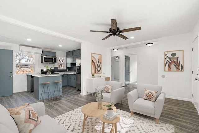 living room with a wall mounted air conditioner, ceiling fan, and light wood-type flooring