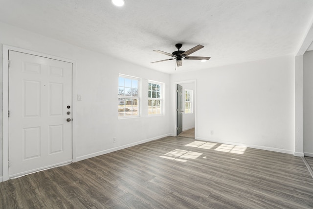 unfurnished room with dark wood-type flooring, ceiling fan, and a textured ceiling