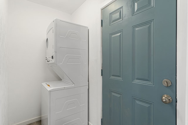 laundry area featuring stacked washer / drying machine