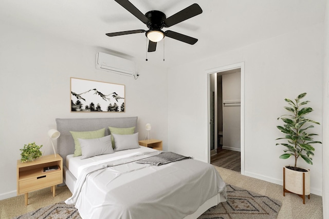 carpeted bedroom with ceiling fan and a wall unit AC