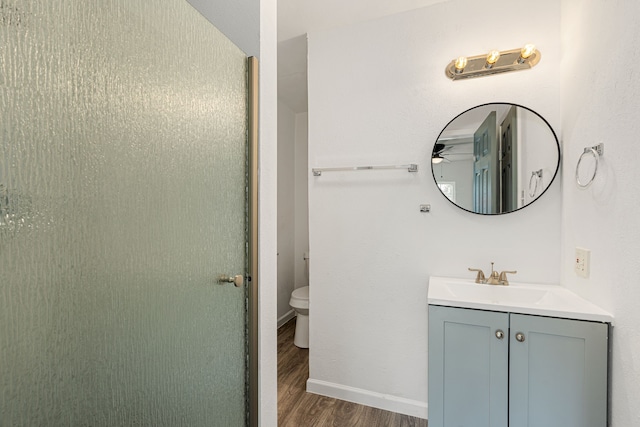 bathroom with vanity, hardwood / wood-style floors, and toilet