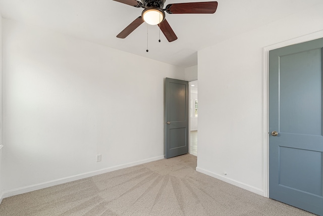 interior space featuring light colored carpet and ceiling fan