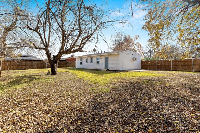 back of property featuring a yard