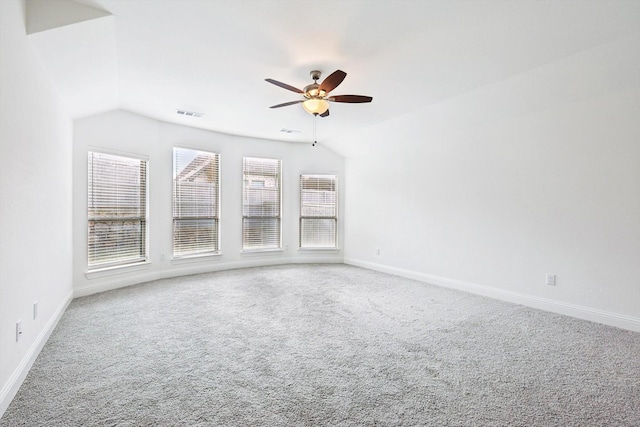 spare room with ceiling fan, carpet floors, and vaulted ceiling