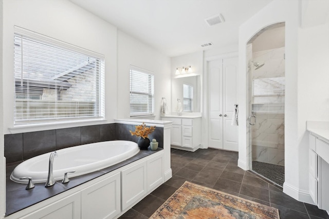 bathroom with vanity, independent shower and bath, and tile patterned flooring