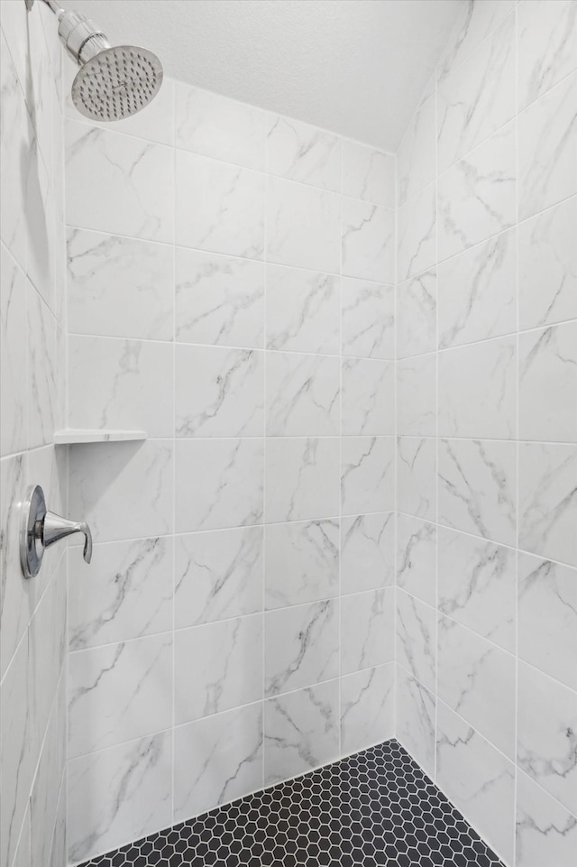 bathroom with tiled shower